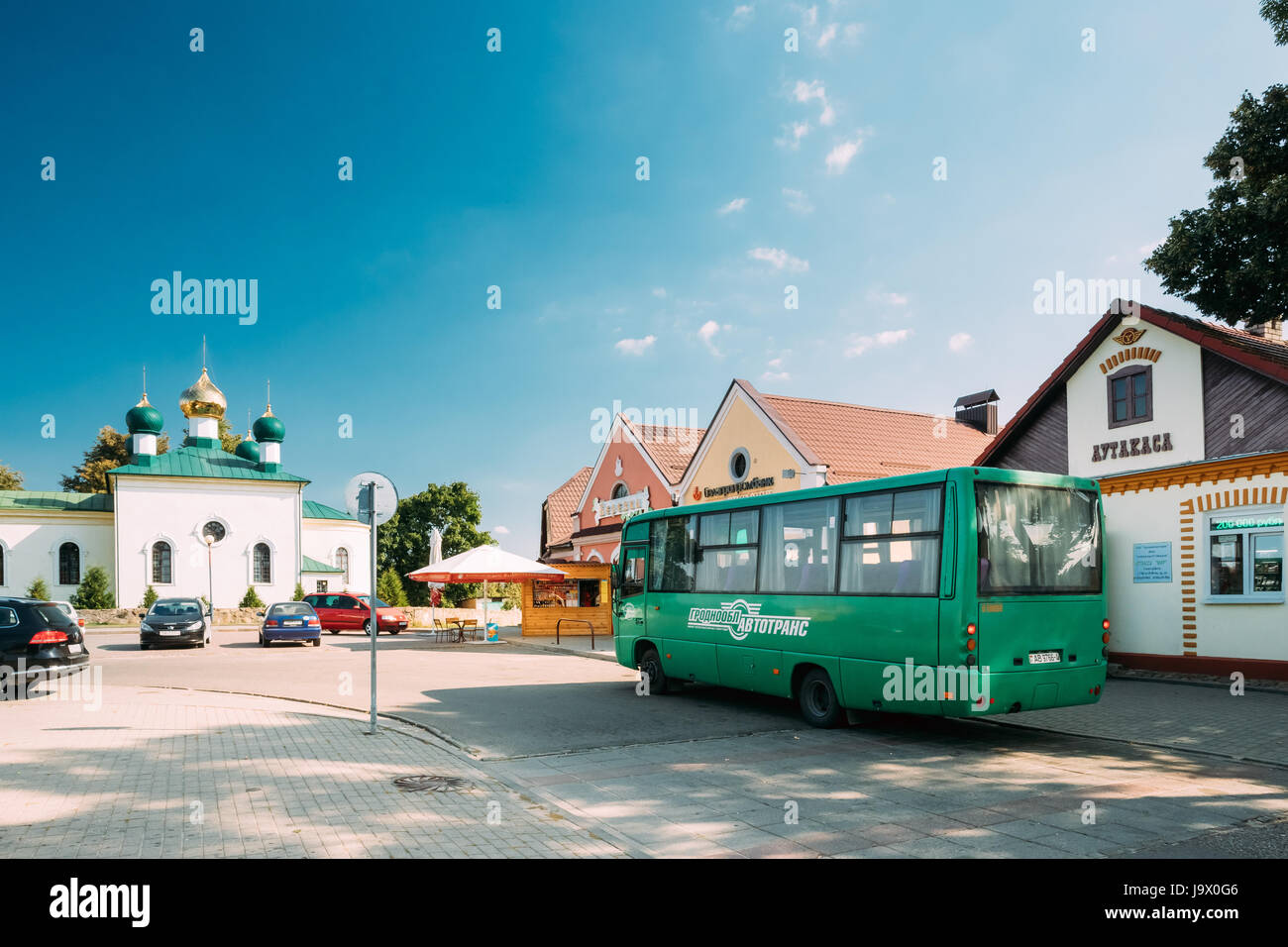 Mir, Belarus - September 2, 2016: Public Bus Car Parked Near Bus Station And Old Orthodox Church Of The Holy Trinity In Mir, Belarus. Famous Landmark  Stock Photo