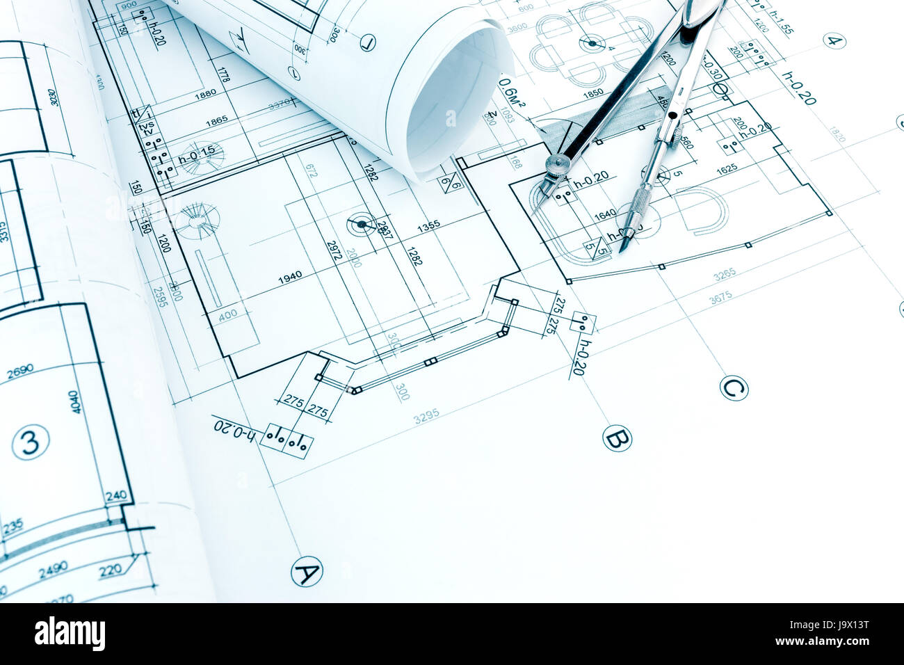 architectural project drawing with rolls of blueprints and drawing compass Stock Photo