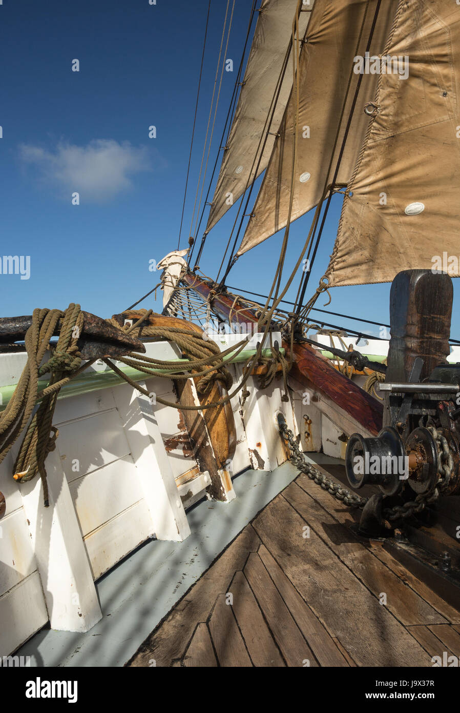 Jib sails and bowsprit on an old sailing ship at sea, taken on a sunny day off the coast of Mull in Scotland Stock Photo