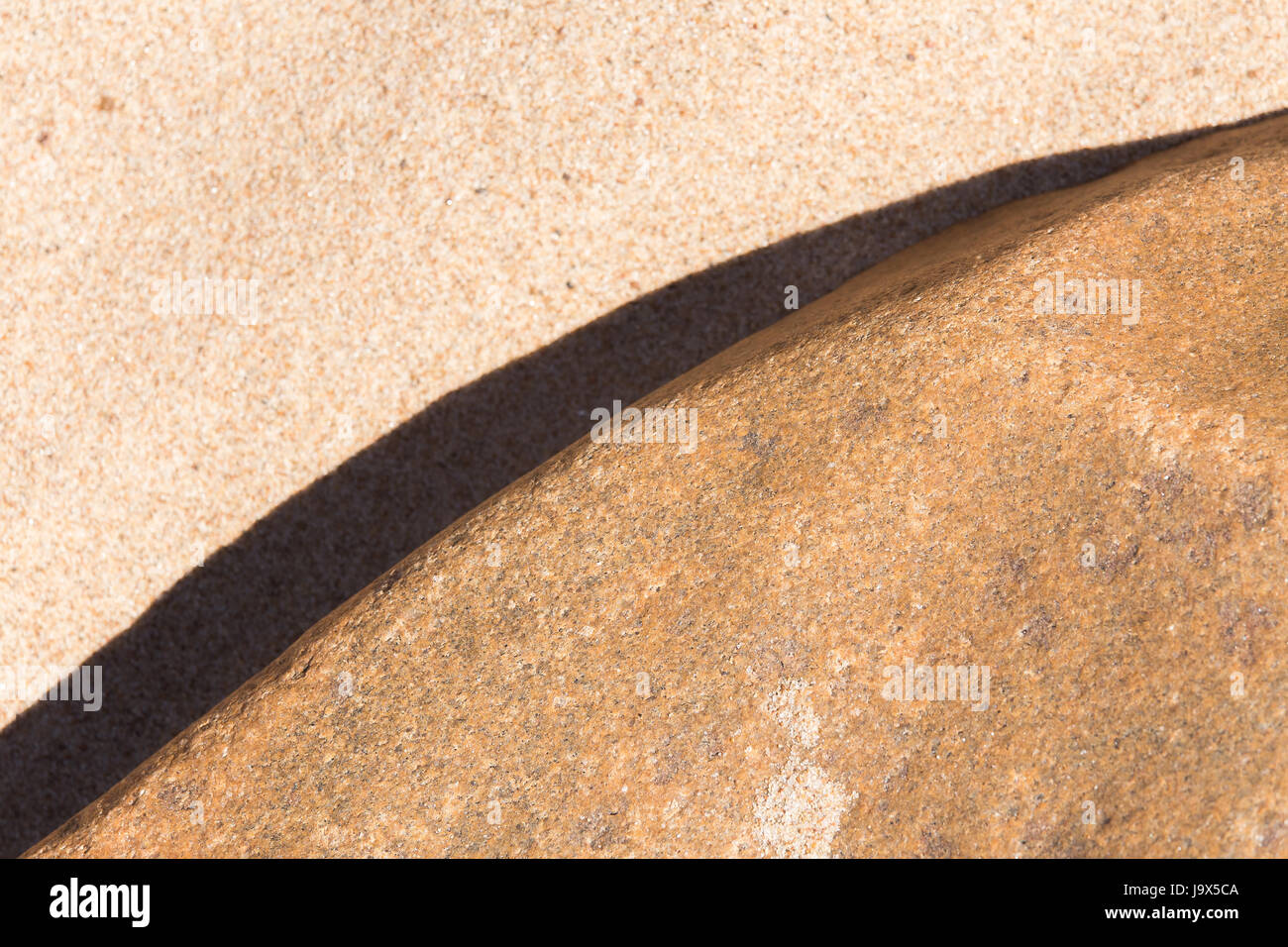 An abstract background of a sea sand and rock shapes. Shallow depth of field. Stock Photo