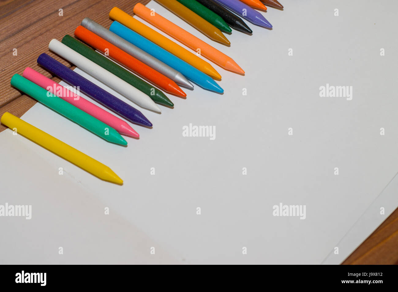 Sketchbook and crayons on a white table. White table and white background  Stock Photo - Alamy