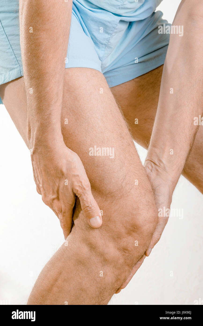 Athlete man feeling pain to the knee. It could be medial meniscus tears, injuries of the collateral lligament, bursitis or Iliotibial band syndrome. Stock Photo