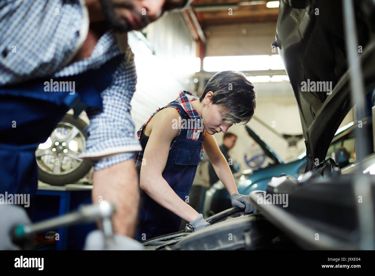 Two mechanics working in car repair service Stock Photo Alamy
