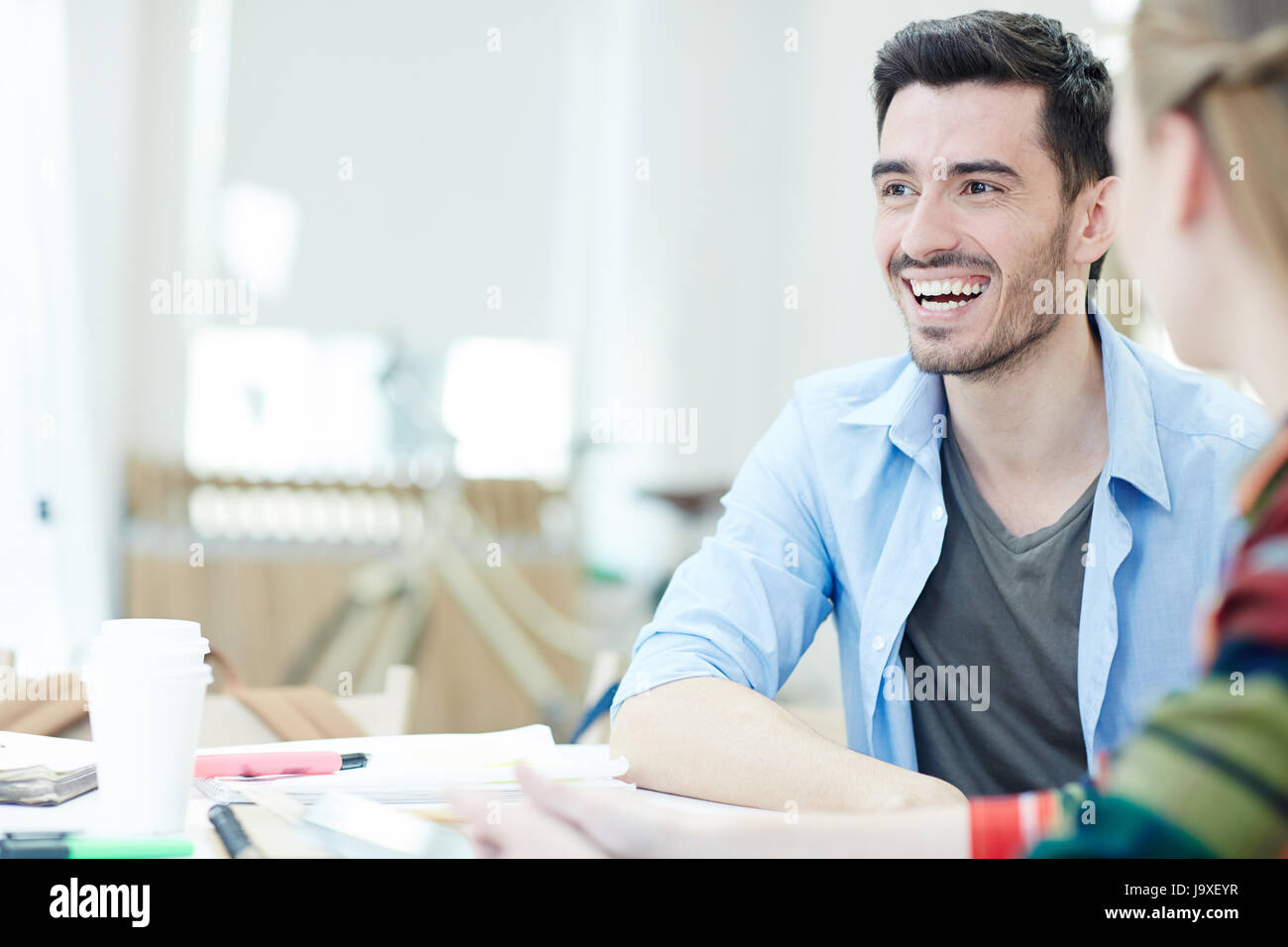 Laughing student and his groupmate during lesson Stock Photo
