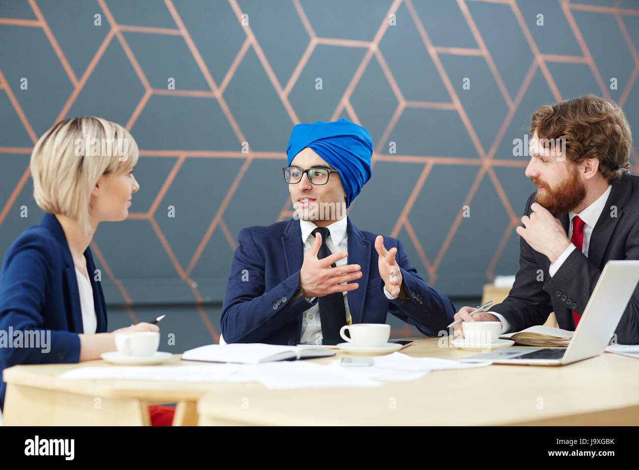 Arabian man in turban giving interview in tv-studio Stock Photo
