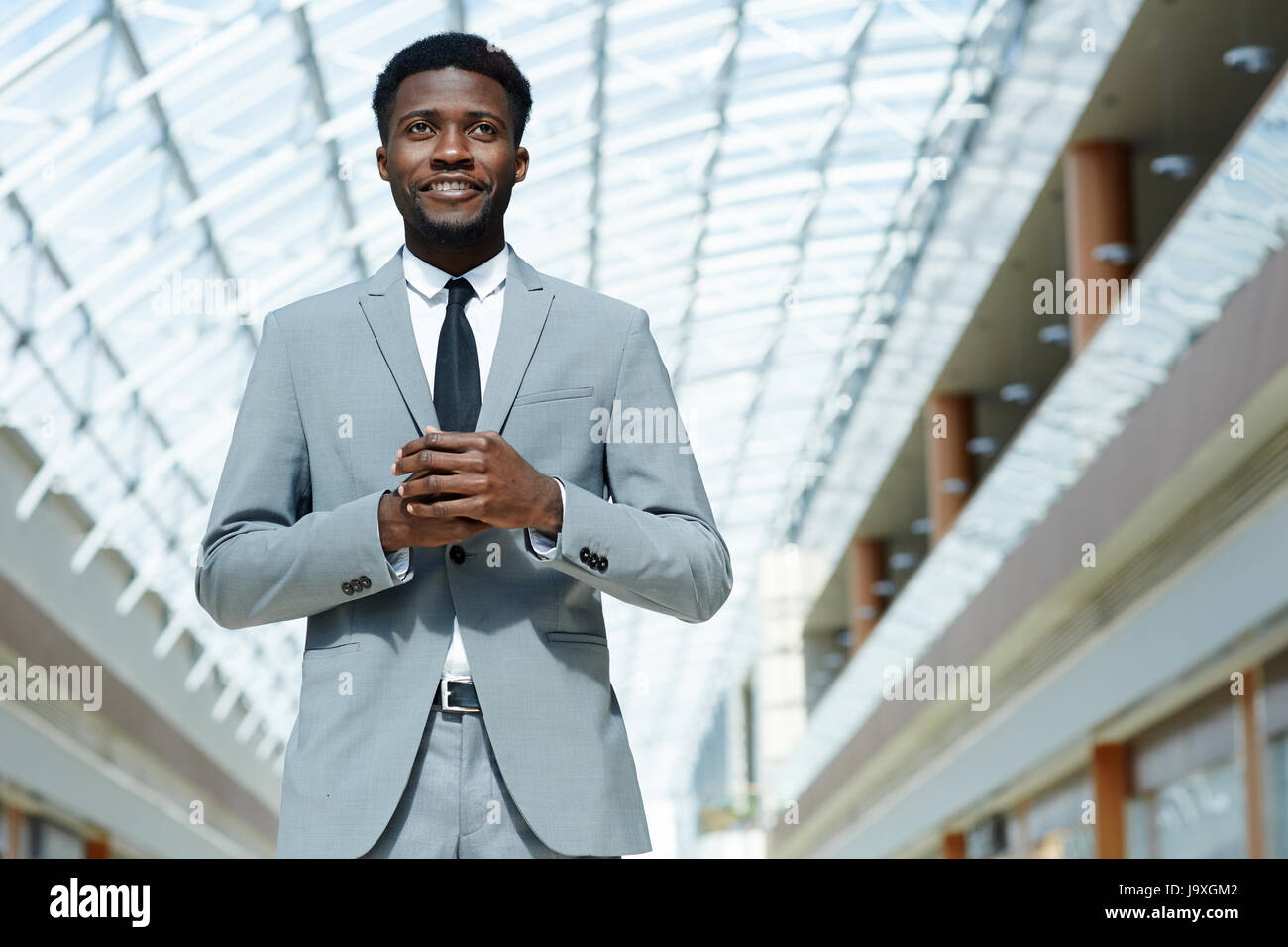 Contemporary young businessman wearing grey suit Stock Photo - Alamy