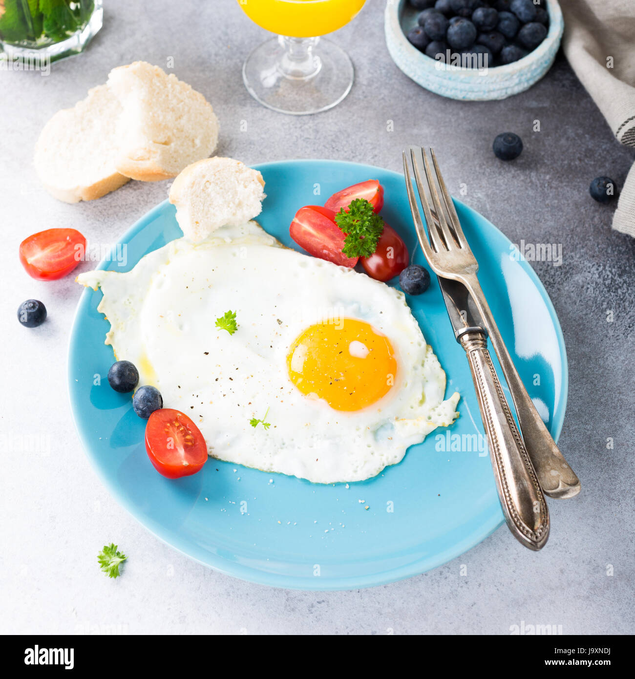 Fried egg and orange juice Stock Photo