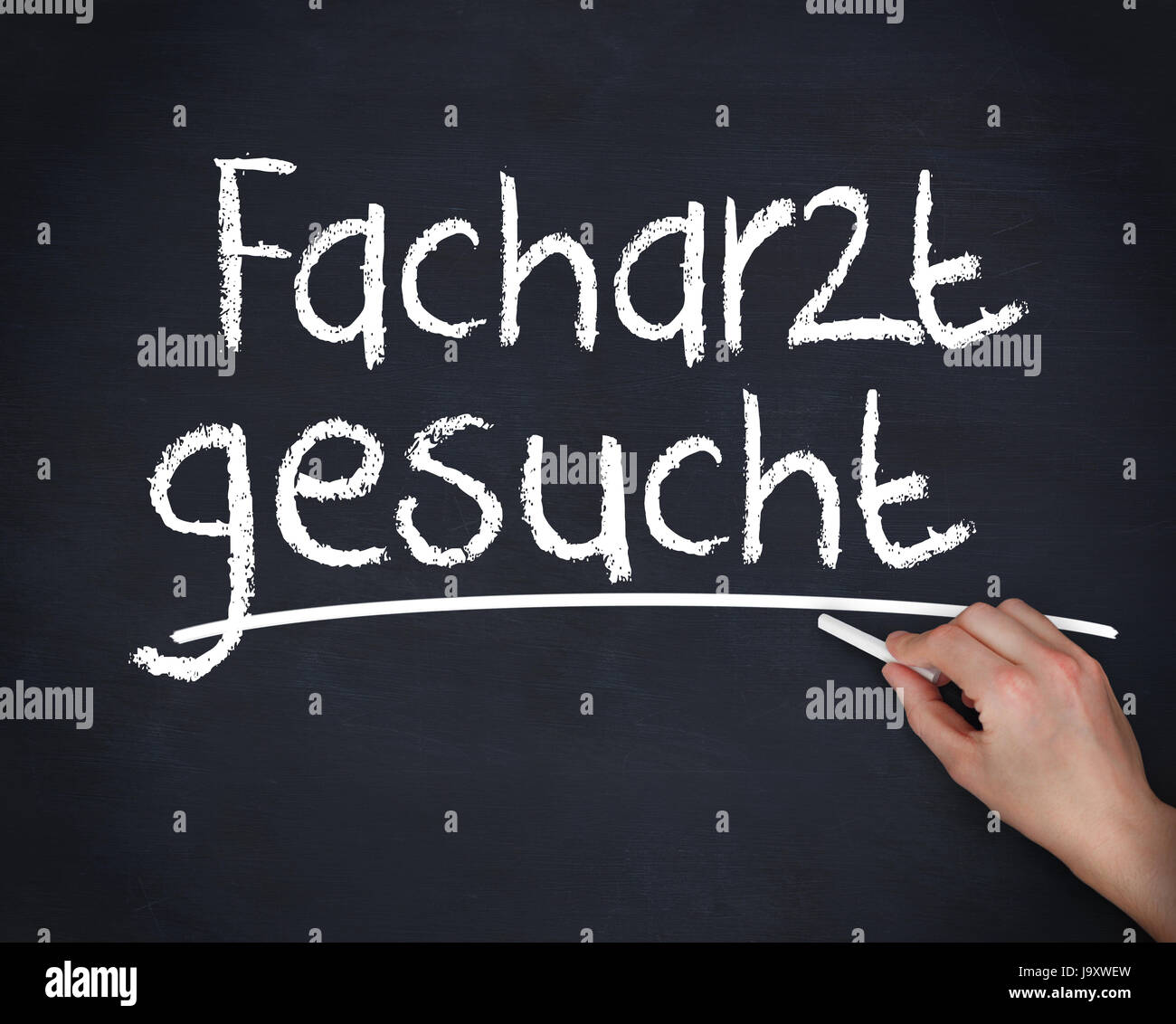 Hand writing facharzt gesucht on a blackboard Stock Photo