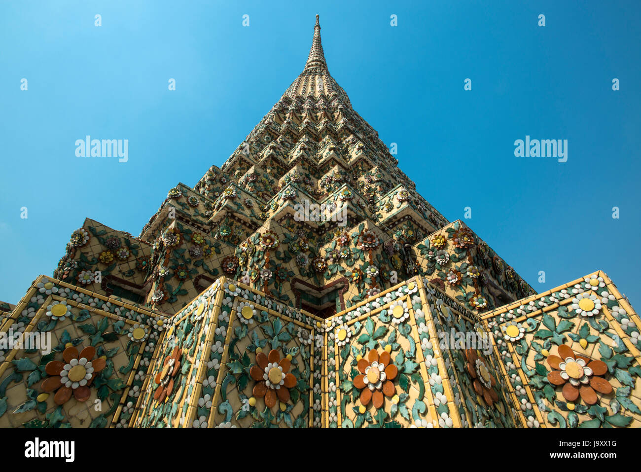 An intricate flower motif mosaic covers a pagoda at Wat Pho, Bangkok, Thailand Stock Photo