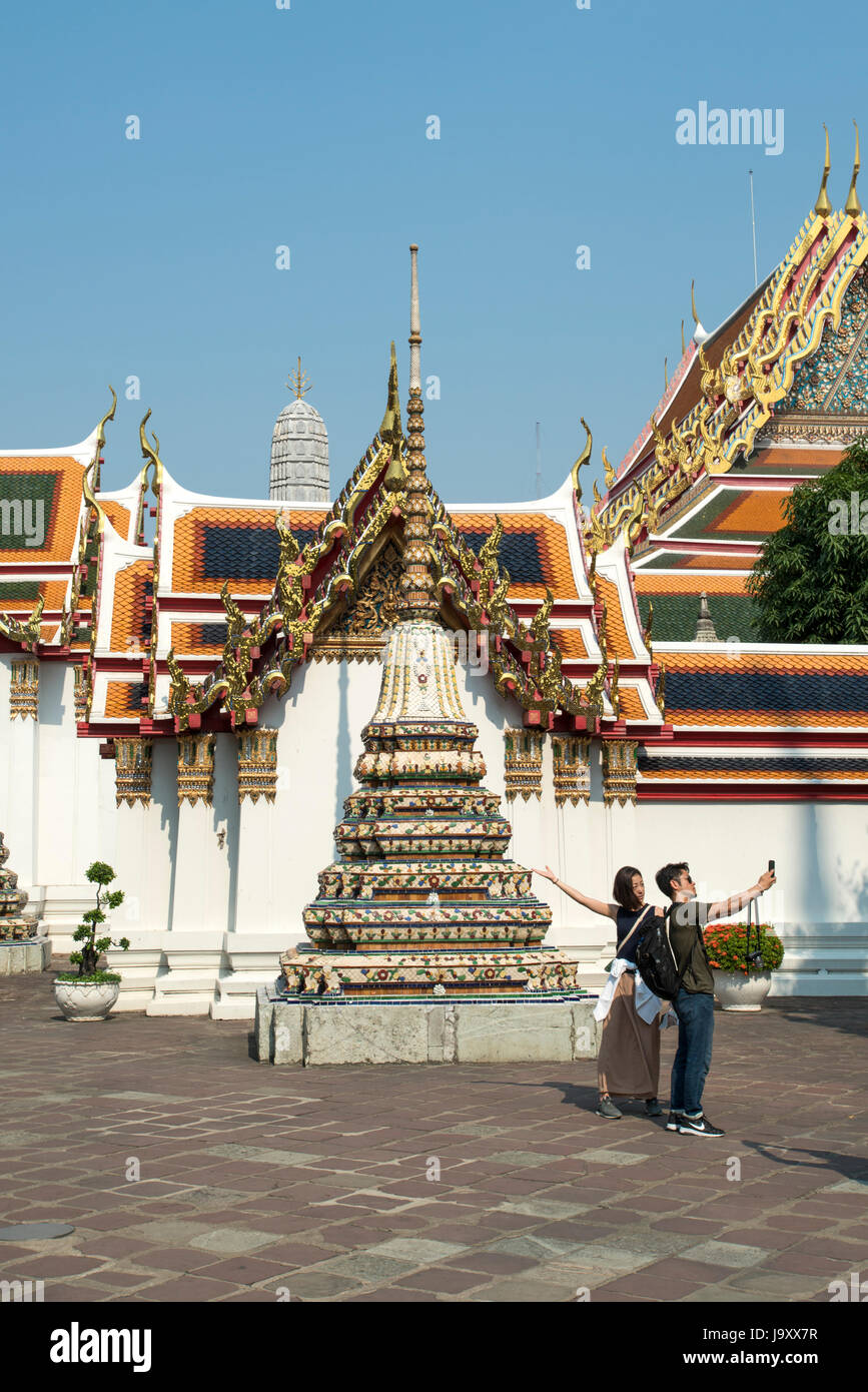 Tourists take photos at Wat Pho, Bangkok, Thailand Stock Photo