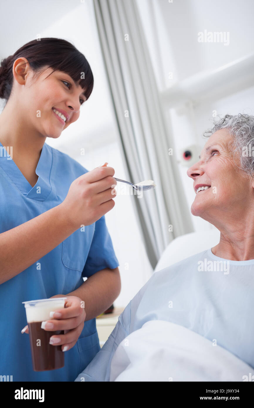 Nurse feeding a patient in hospital ward Stock Photo Alamy