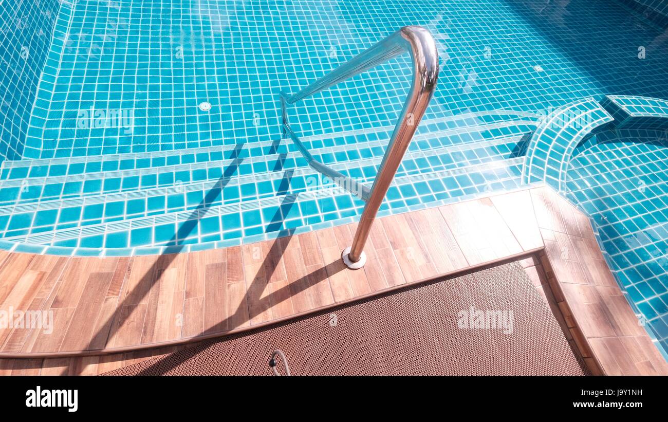 Summer Physical Fitness Fun Swimming Pool Safety Hand Rail Ladder Steps into Pool Stock Photo