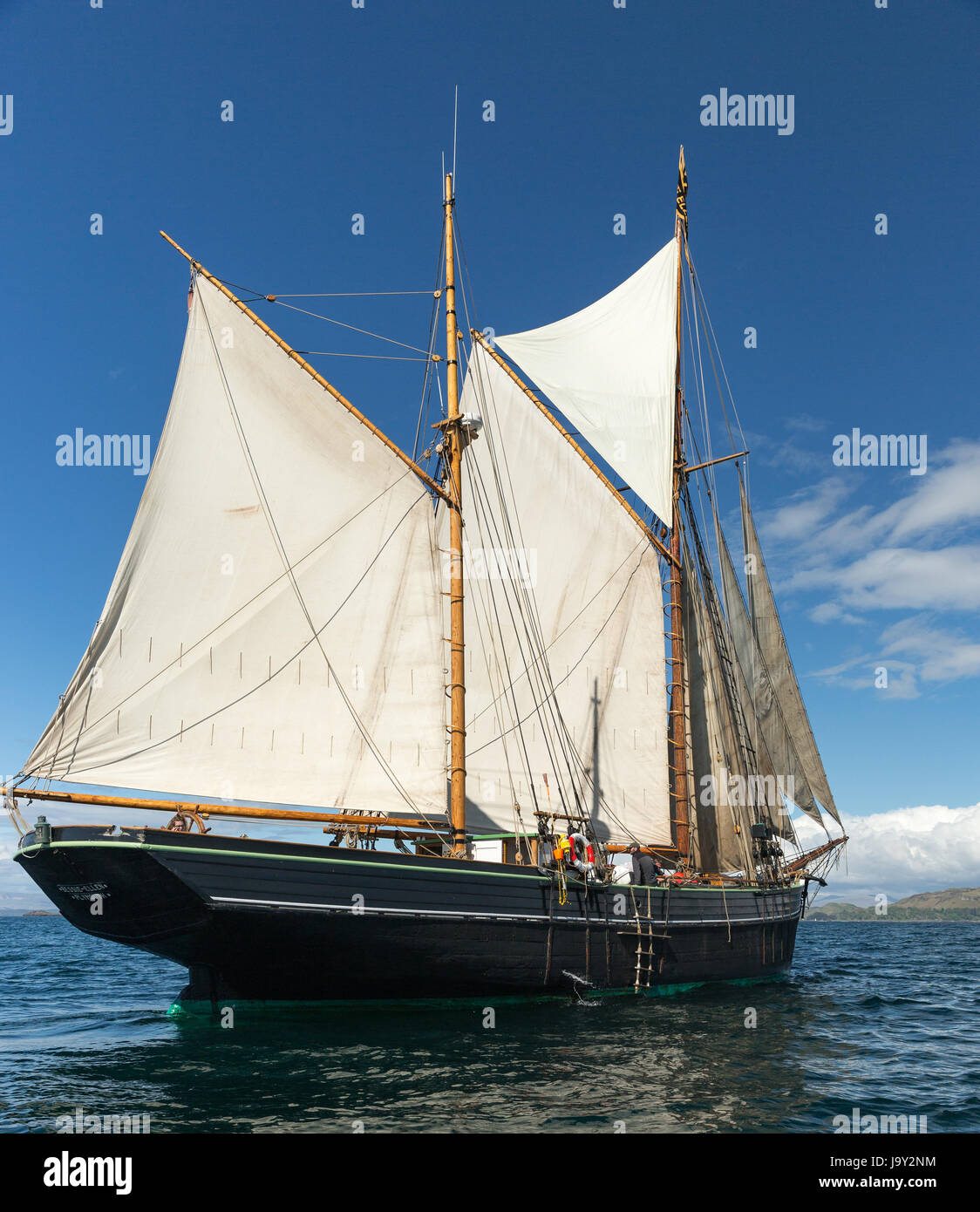 Twin masted sailing ship off the island of Kerrera, Oban, Scotland taken offshore from Gylan Castle Stock Photo