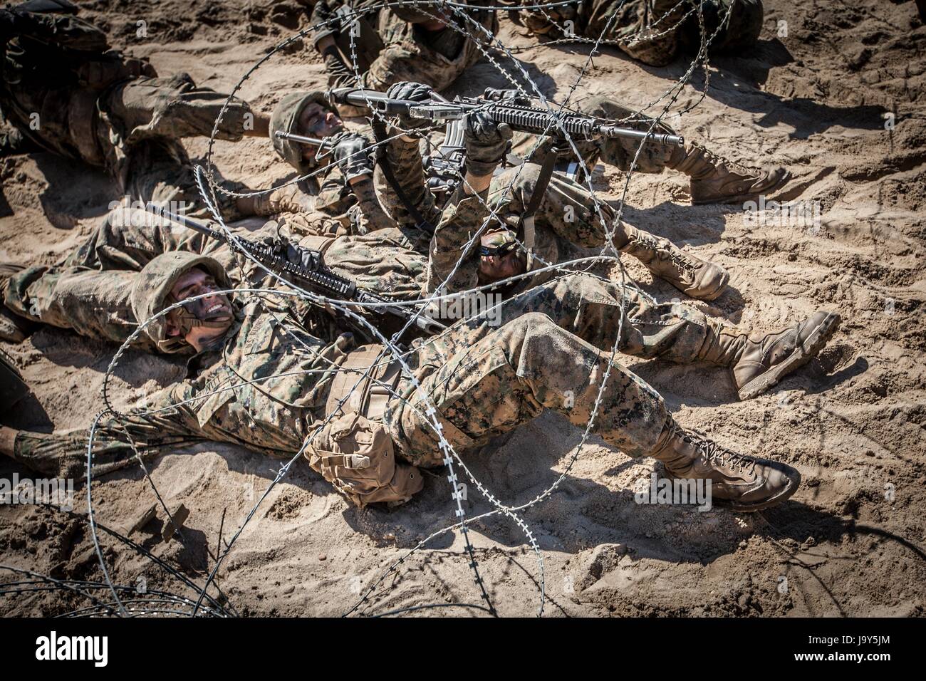 U.S. Marine Corps recruits crawl under the barbed wire Crucible during recruit training at the Marine Corps Recruit Depot Parris Island October 16, 2015 in Parris Island, South Carolina.    (photo by Melissa Marnell /US Marines via Planetpix) Stock Photo