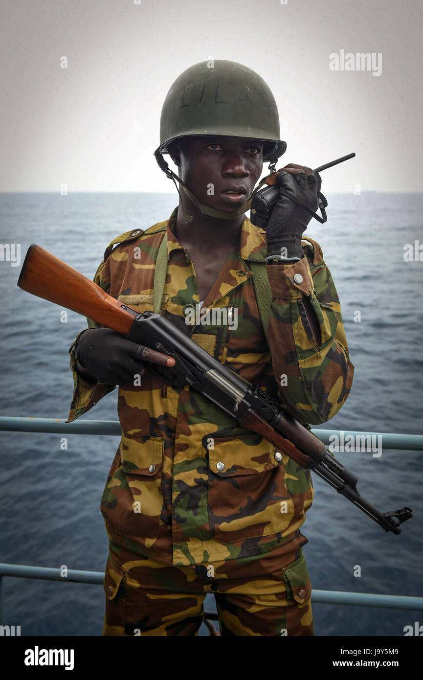 A Togolese soldiers uses a handheld radio while aboard the German Navy Type F123 Brandenburg-class frigate FGS Brandenburg during a simulated drug smuggling scenario for exercise Obangame Express March 26, 2015 in the Gulf of Guinea.     (photo by Raul Pacheco /US Army  via Planetpix) Stock Photo