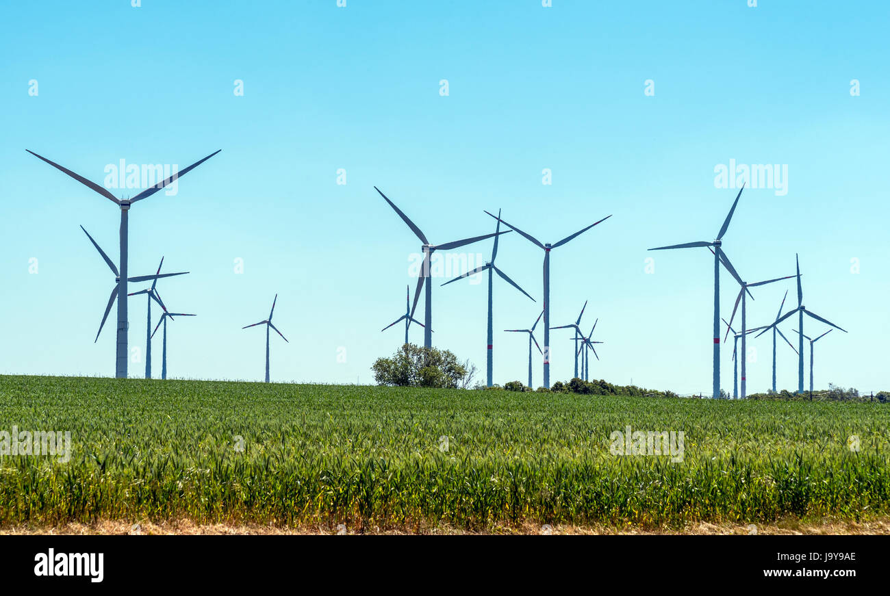 Wind turbines with back light seen in rural Germany Stock Photo