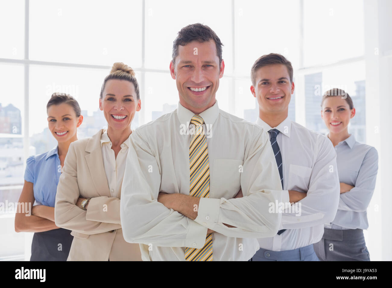 Portrait of business team standing together in their office Stock Photo ...