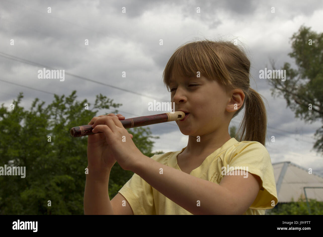 Girl plays on pipe Stock Photo