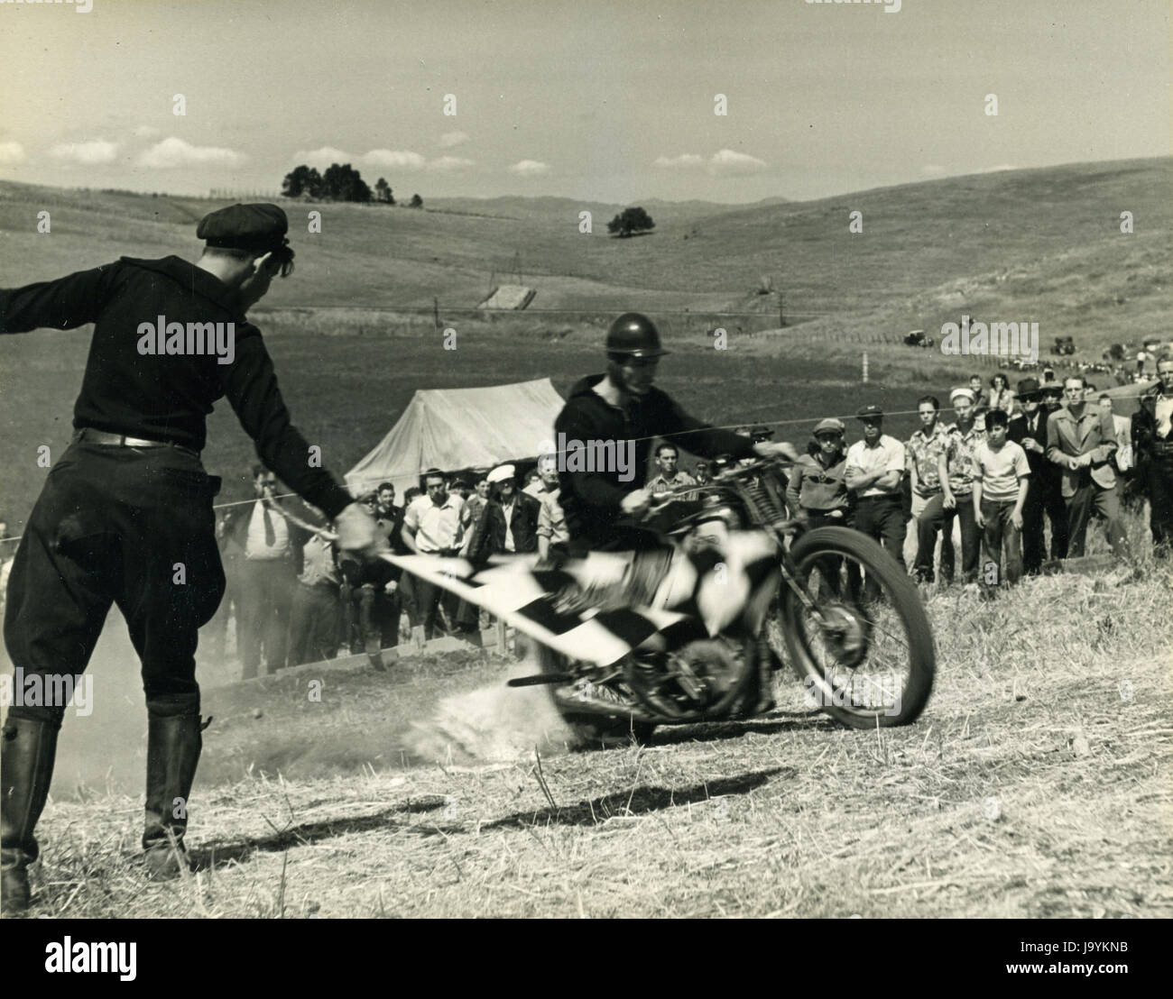 Santa Clara County, April 5, 1940 - Breaking the starting tape at the beginning of the Motorcycle Hill Climb. Stock Photo