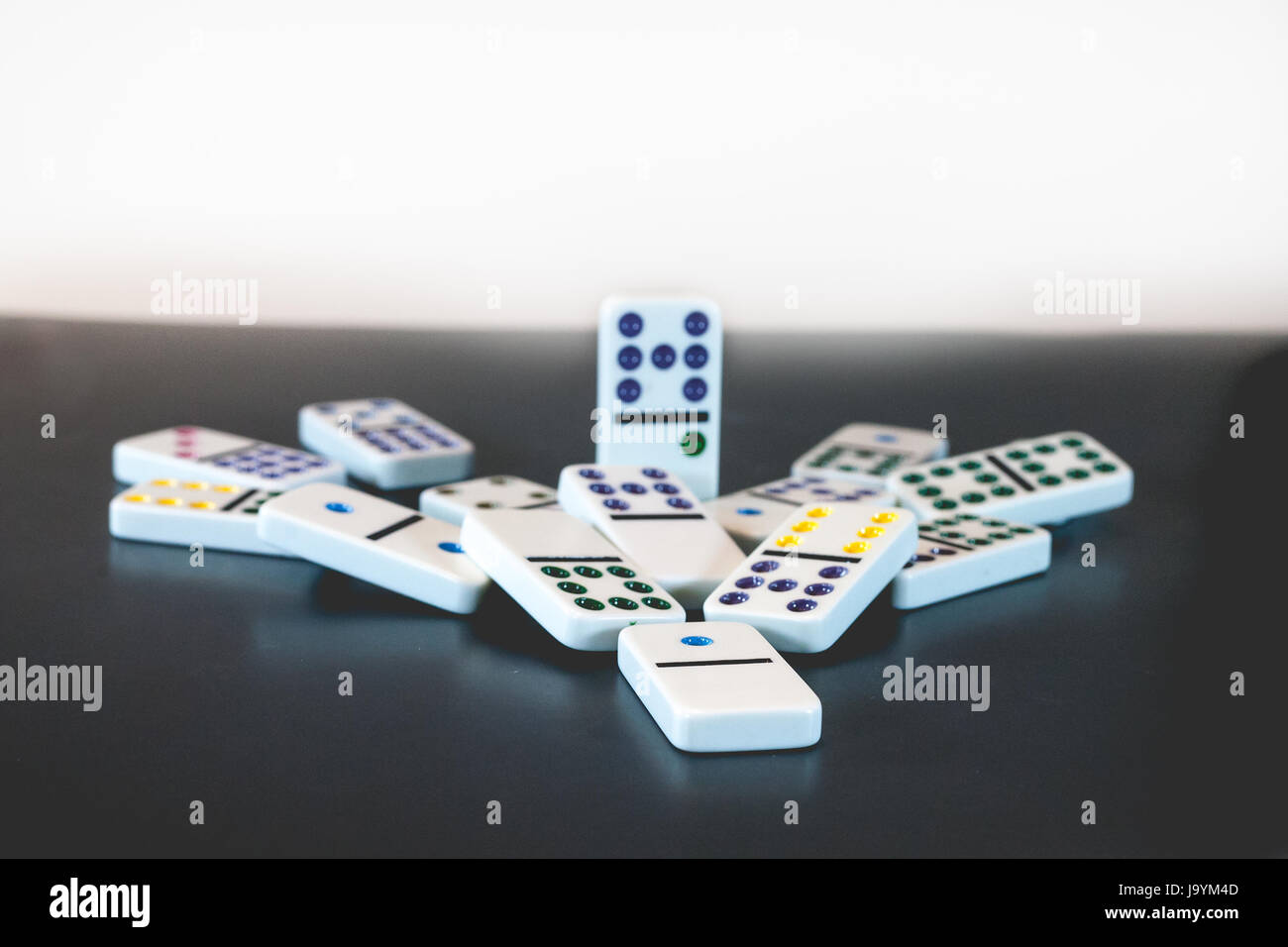A single domino left standing after all others have fallen. Stock Photo