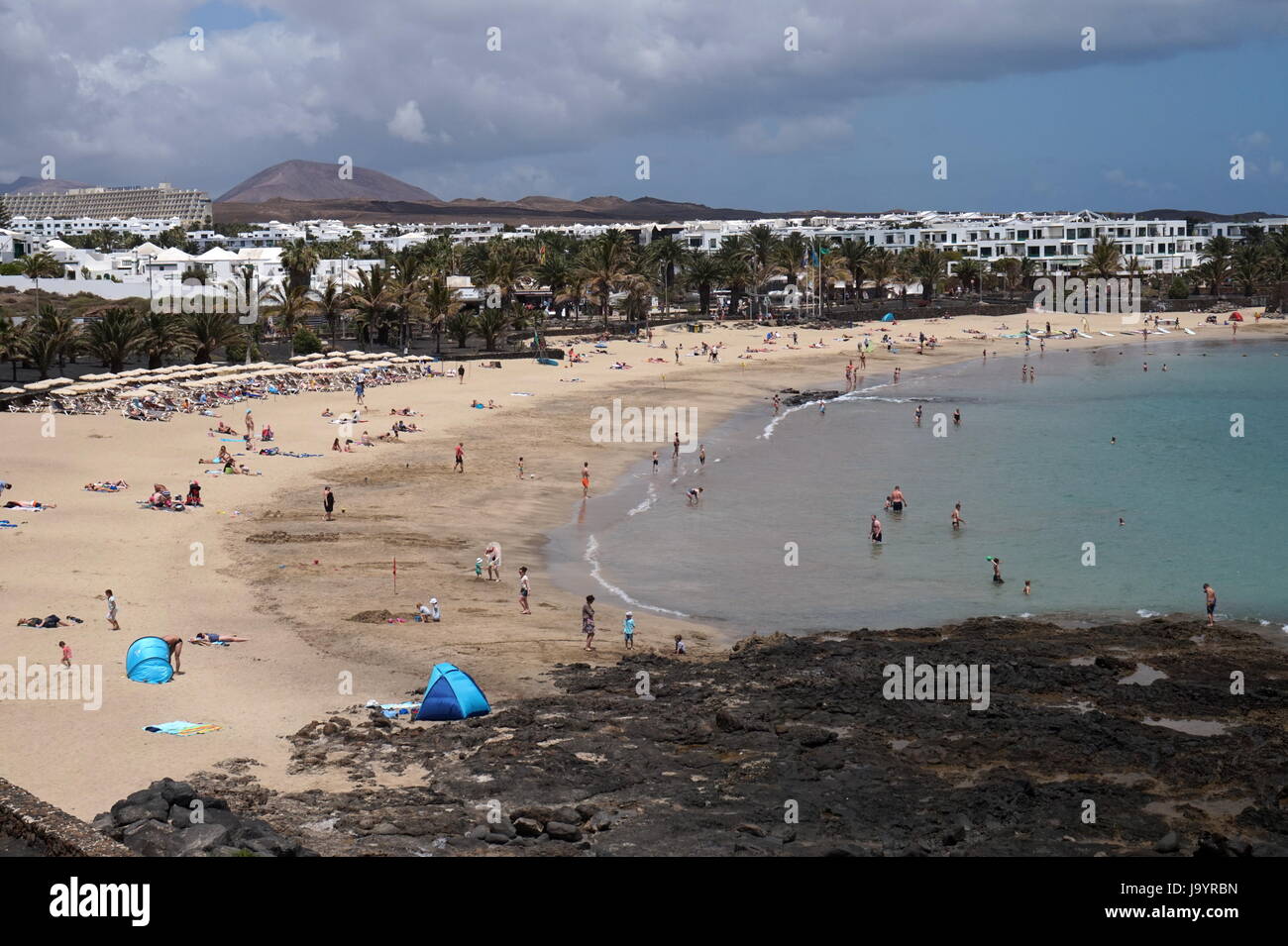 Holidaymakers on Playa las Cucharas, Costa Teguise, Lanzarote, Spain Stock Photo