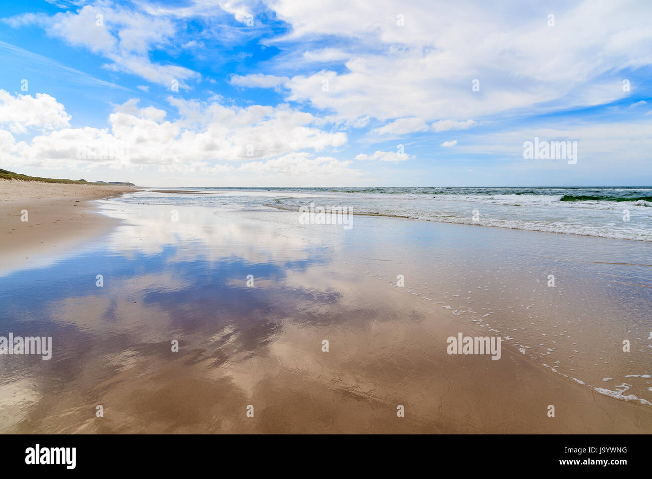 Wet sand and clouds reflections on List beach, Sylt island, North Sea, Germany Stock Photo