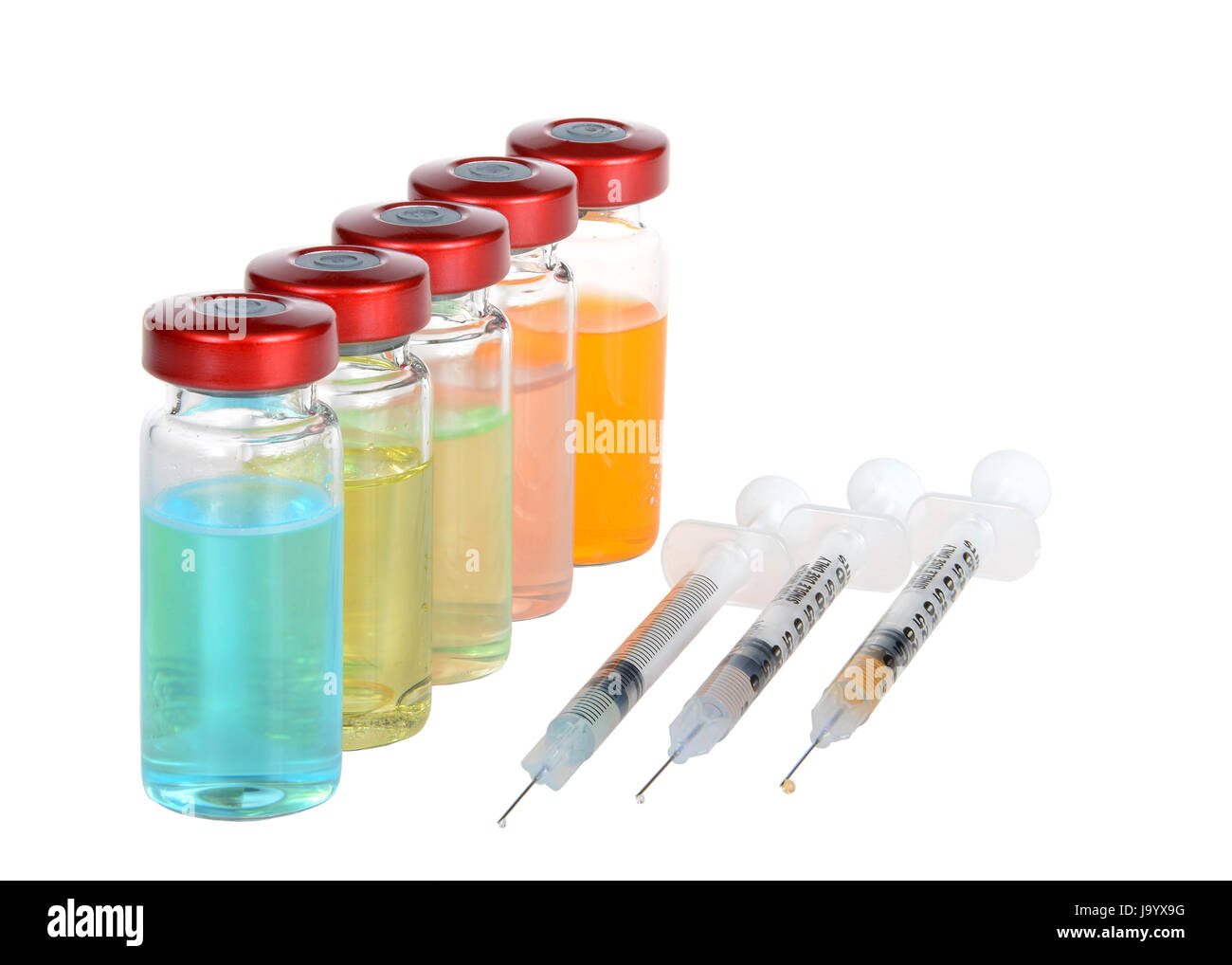 Five Vials of medication exaggerated psychedelic with bright color of fluid. Three syringes with drugs and a drop of fluid at the needle tip. Isolated Stock Photo
