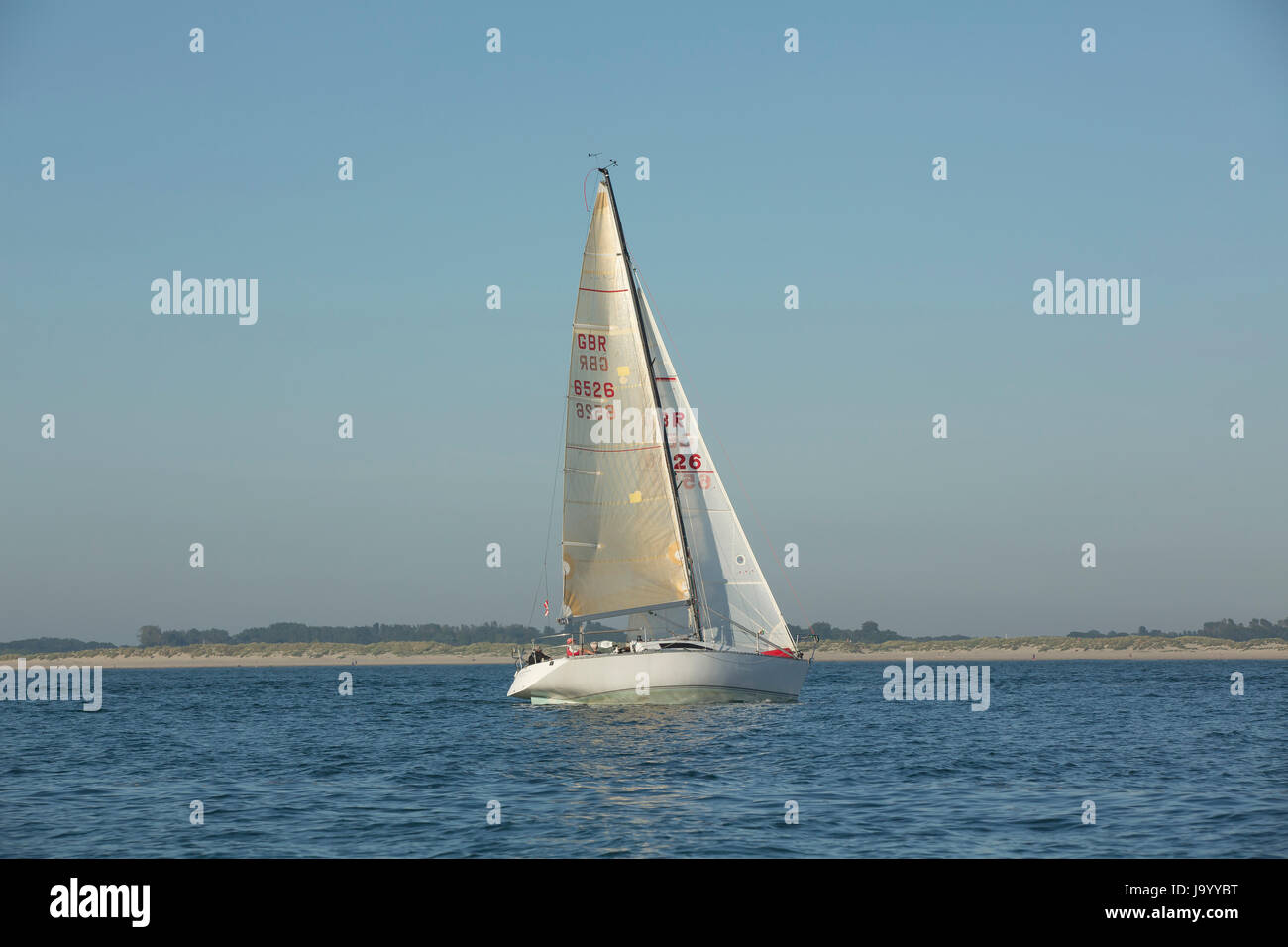 Single yacht at the entrance to Chichester harbour Stock Photo Alamy