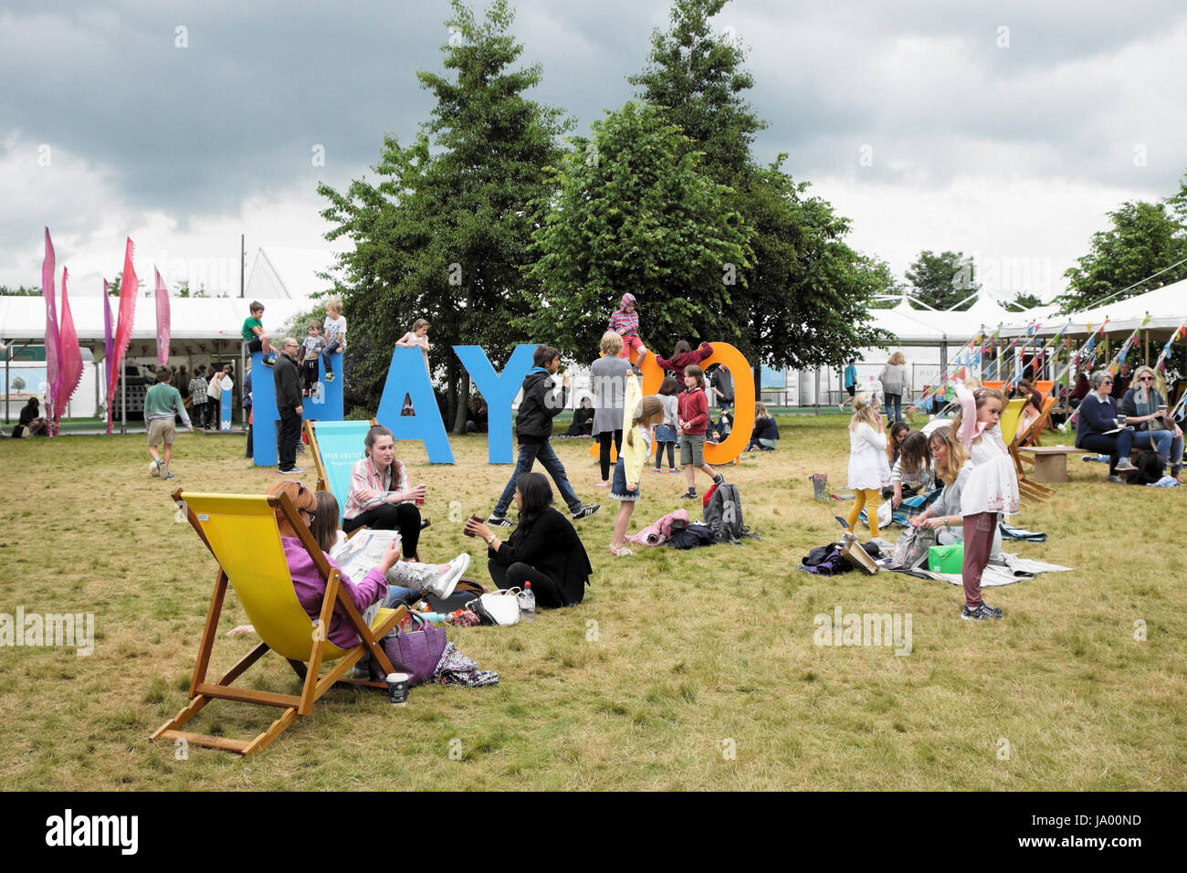 Kids playing outside climbing on the Hay 30 sign celebrating the 30th year of the Hay Festival, Hay-on-Wye, Wales UK    KATHY DEWITT Stock Photo