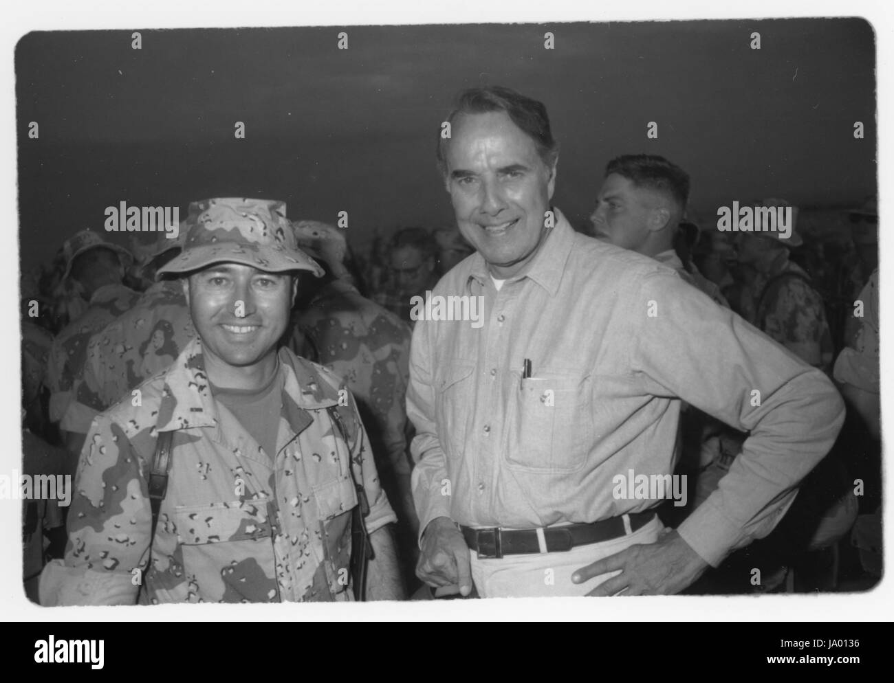 Senator Robert Dole pauses for a photo with a Marine while paying a Thanksgiving Day visit to the 1st Marine Division combat operations center during OPERATION DESERT SHIELD, Saudi Arabia, 11/23/1990. Stock Photo