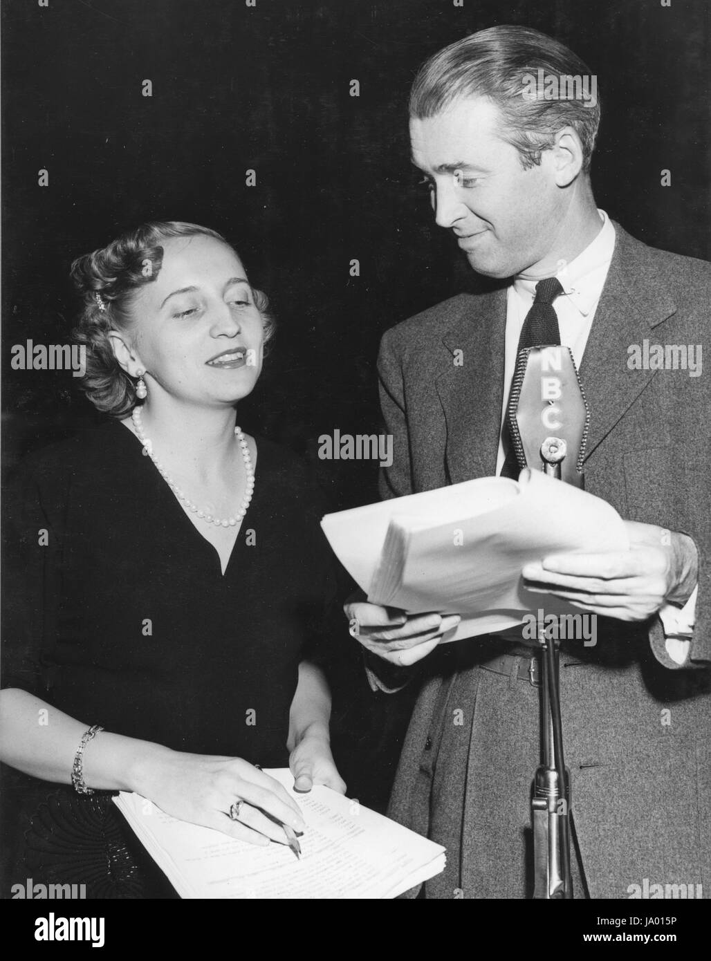 Margaret Truman, daughter of President Harry S. Truman, conferring with actor Jimmy Stewart before the two appeared together in a radio drama, Hollywood, CA, 04/01/1951. Stock Photo
