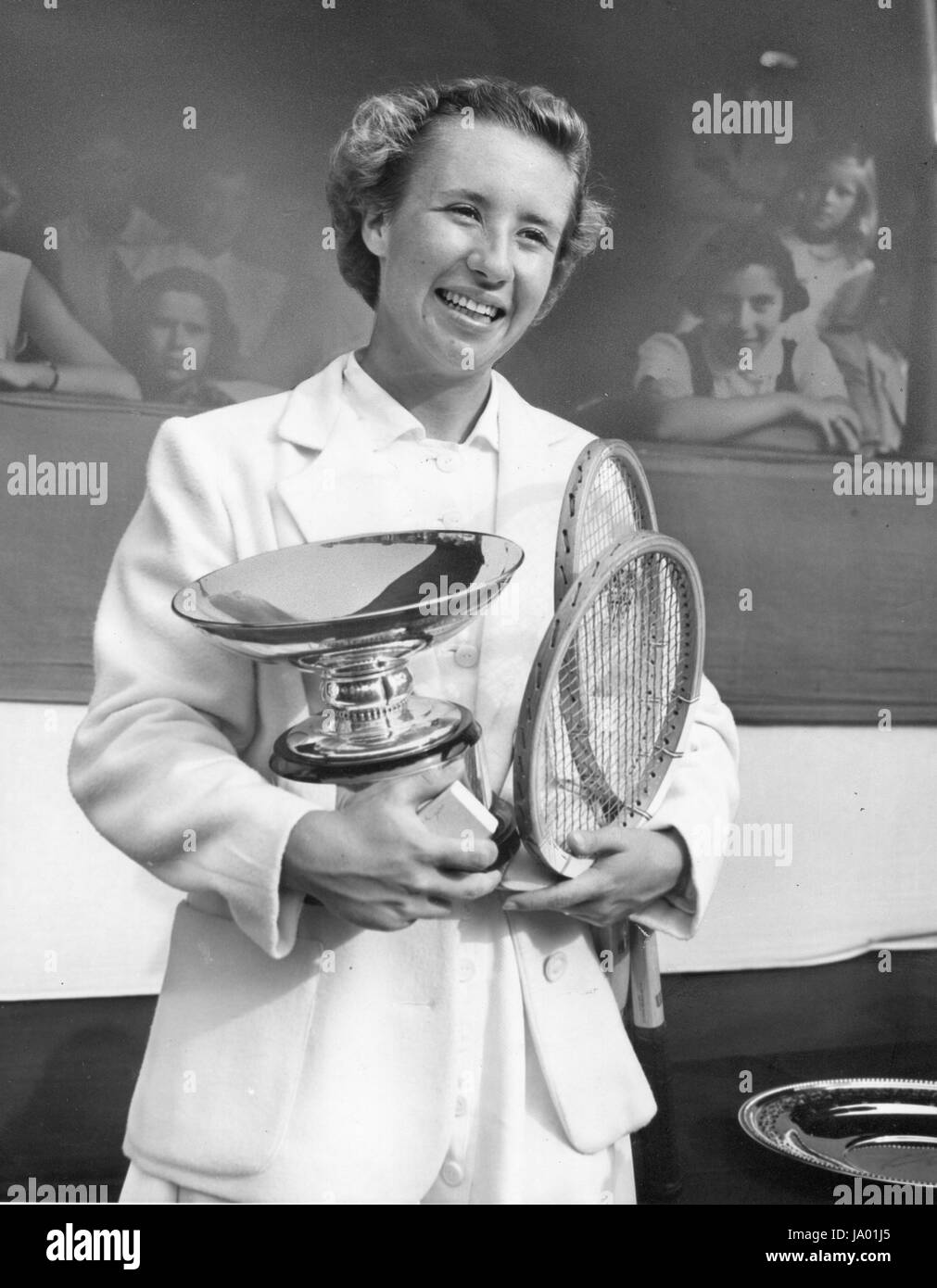 Maureen Connolly, US National women's singles tennis champion, holds her championship cup, Forest Hills, NY, 09/1951. Stock Photo