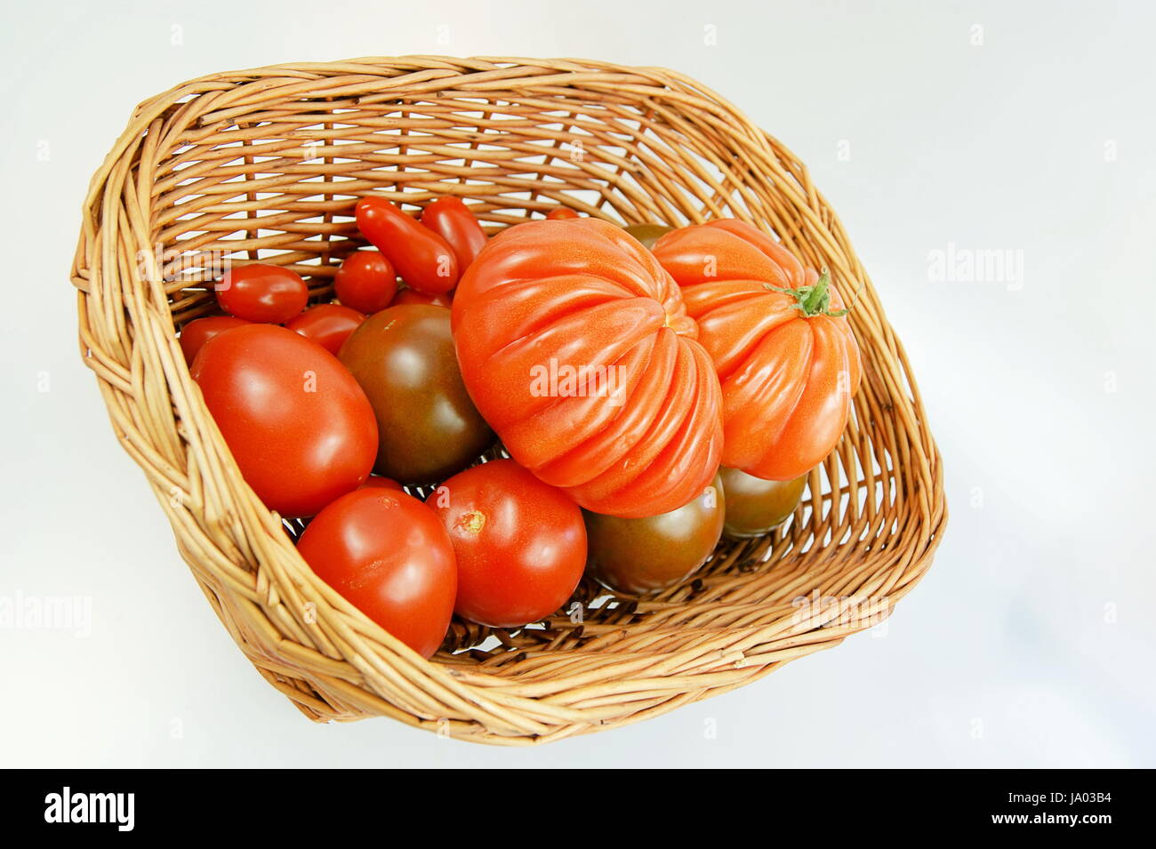 tomatoes in basket Stock Photo - Alamy