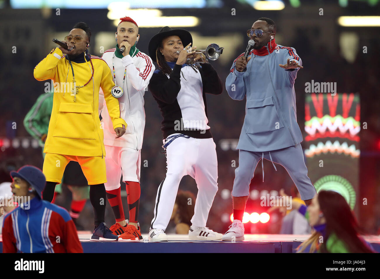 apl.de.ap (left), will.i.am (right) and Taboo (second left) of Black Eyed Peas perform before the UEFA Champions League Final at the National Stadium, Cardiff. Stock Photo