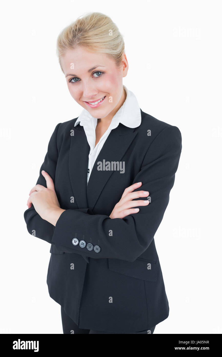 Portrait of confident young business woman standing with arms crossed ...