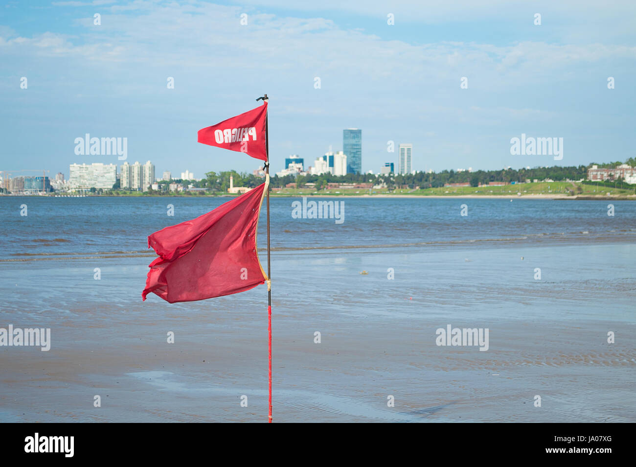 red flag waving on the uruguayan coast Stock Photo