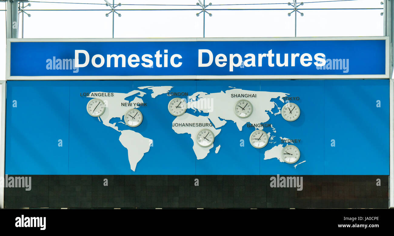 Clocks in an airport showing the time of different major cities Stock
