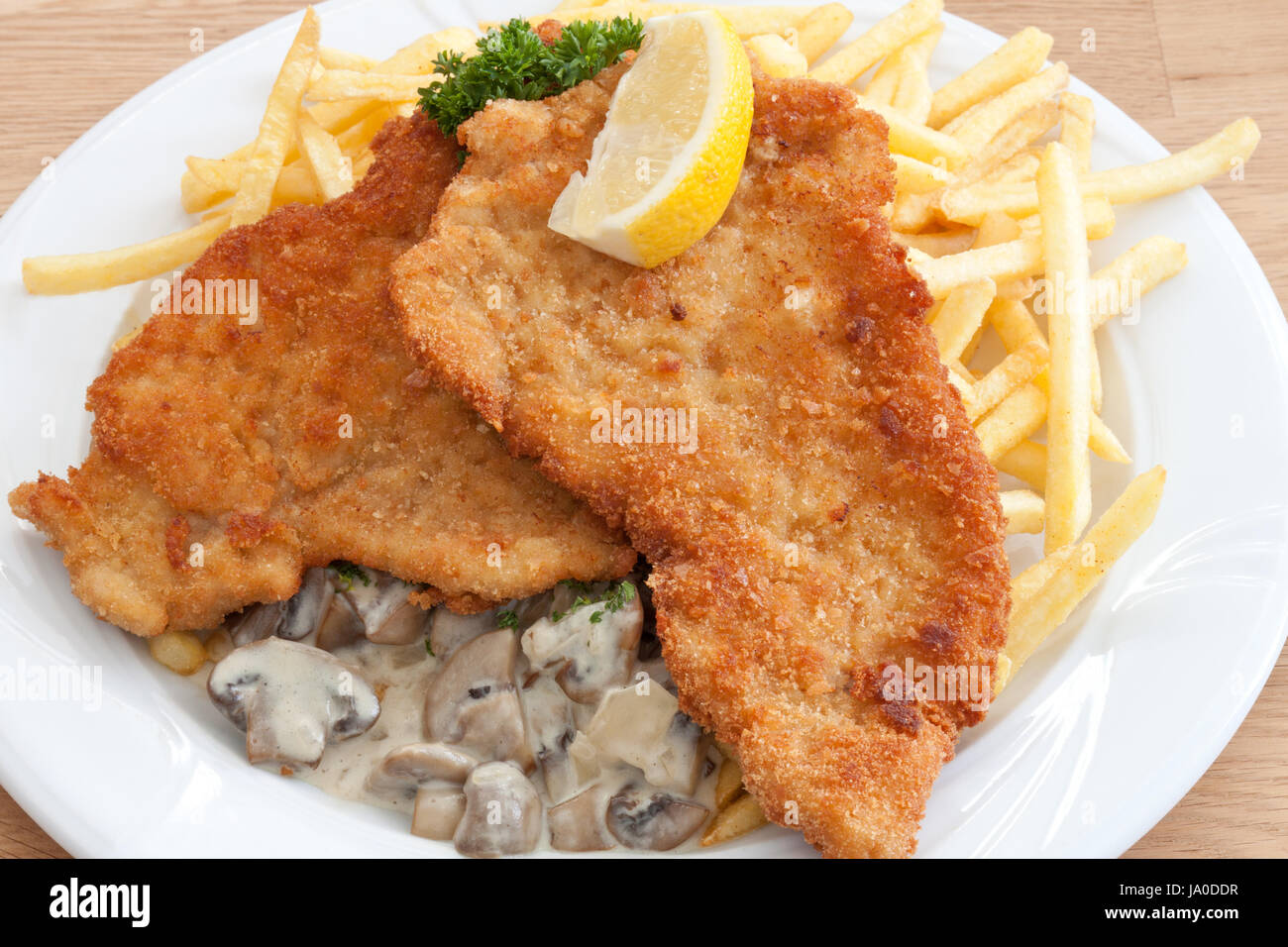 pork escalope viennese style with chips Stock Photo Alamy