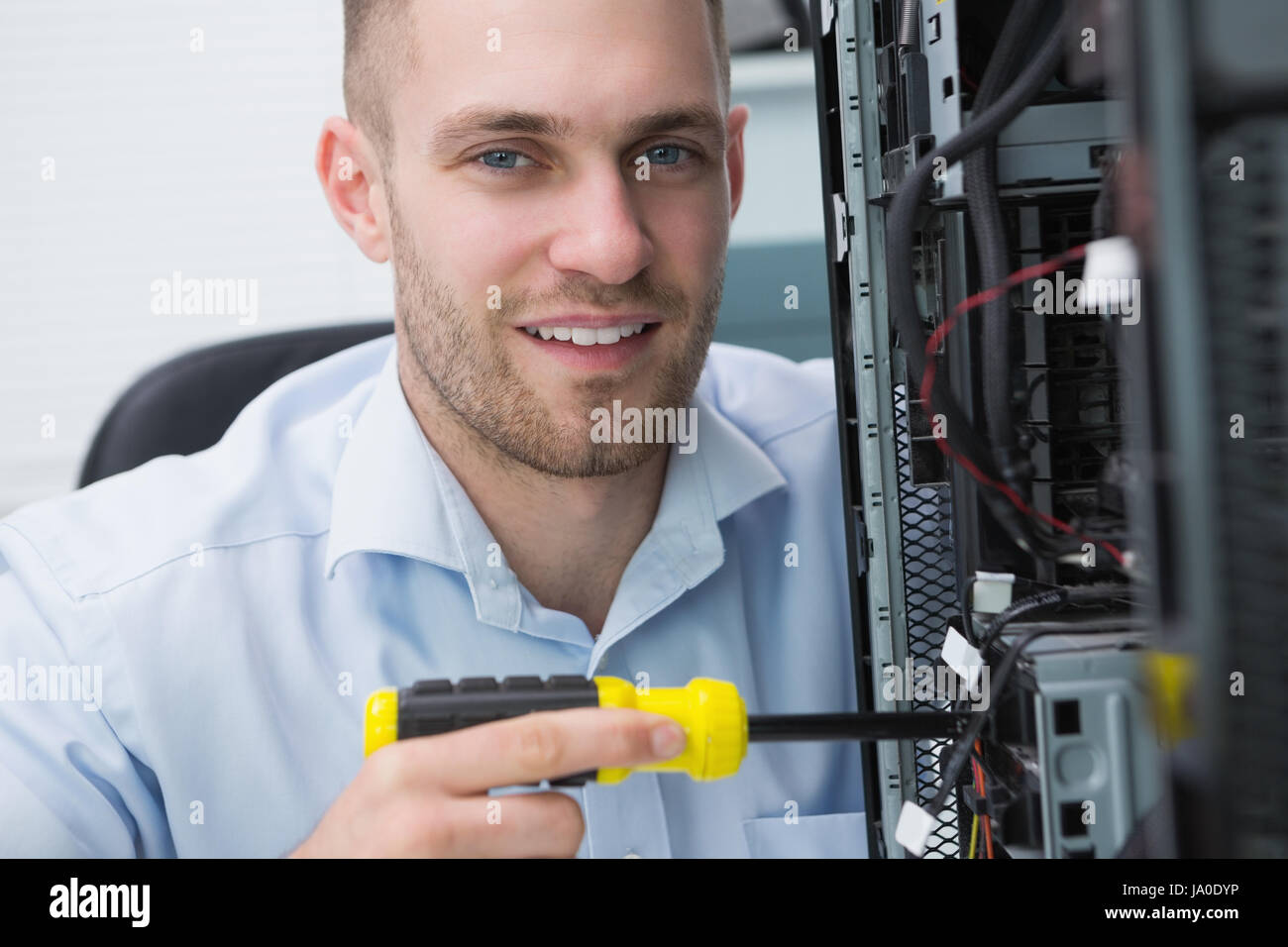 Closeup portrait of young computer engineer working on cpu Stock Photo