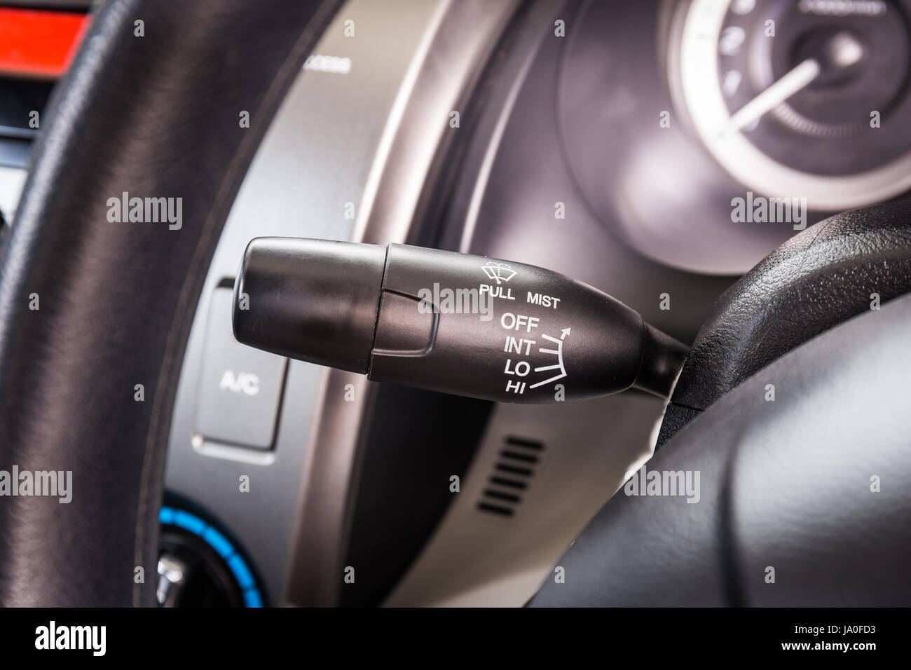 Wipers control in modern car interior detail adjusting speed of screen