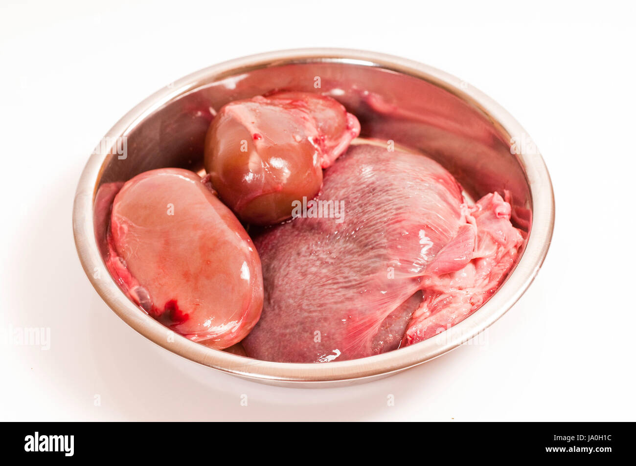 fresh kidney and spleen to the raw diet in stainless steel bowls Stock Photo