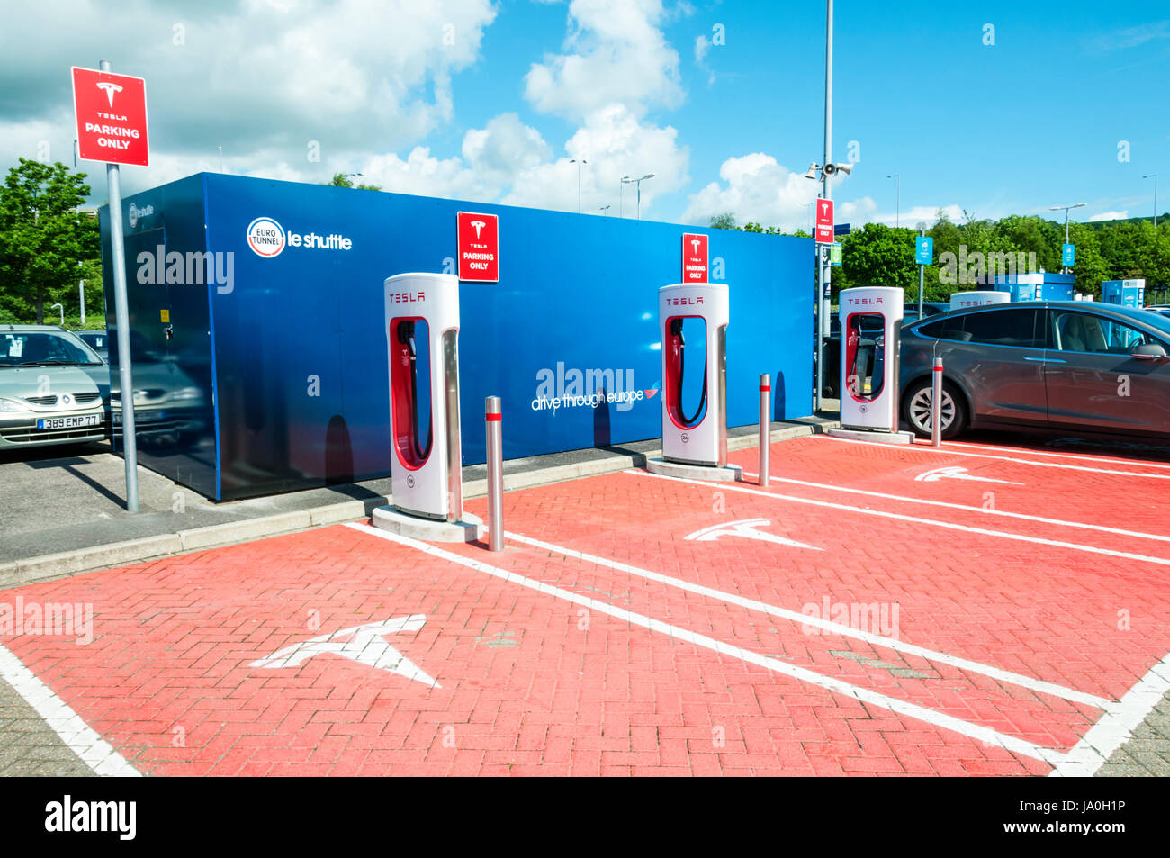 Electric car recharging point for Tesla electric cars at the British Eurotunnel terminal. Showing the Tesla name and logo. Stock Photo