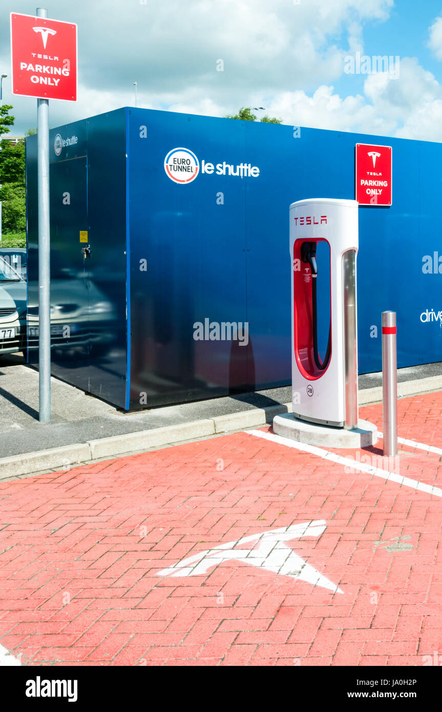 Electric car recharging point for Tesla electric cars at the British Eurotunnel terminal. Showing the Tesla name and logo. Stock Photo