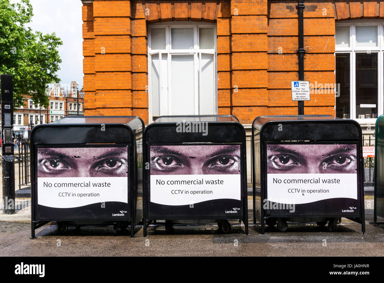 Signs warn against putting commercial waste in public rubbish bins. Stock Photo