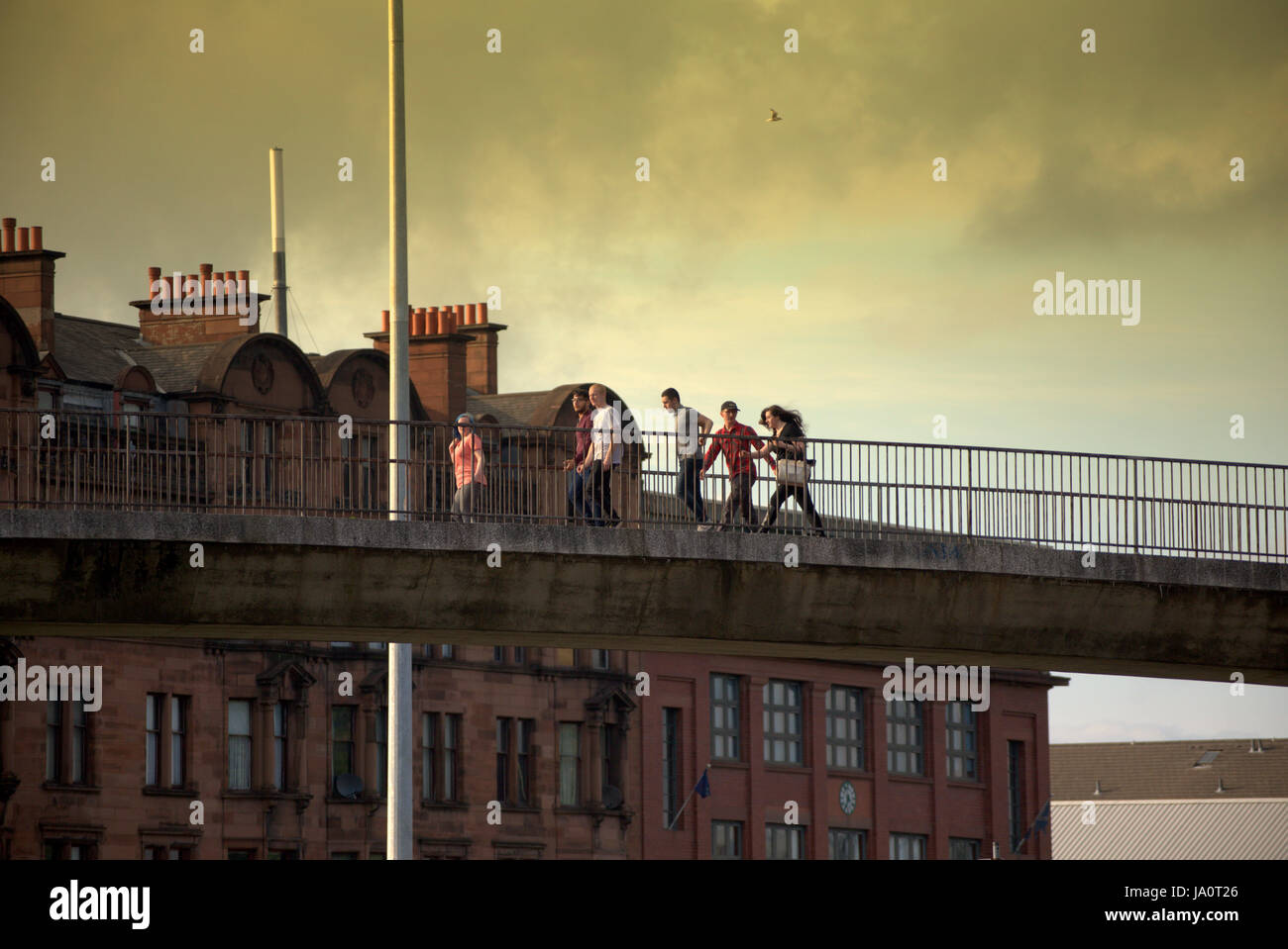 tourists on the streets of Glasgow Scotland crossing road bridge at Charring Cross Stock Photo