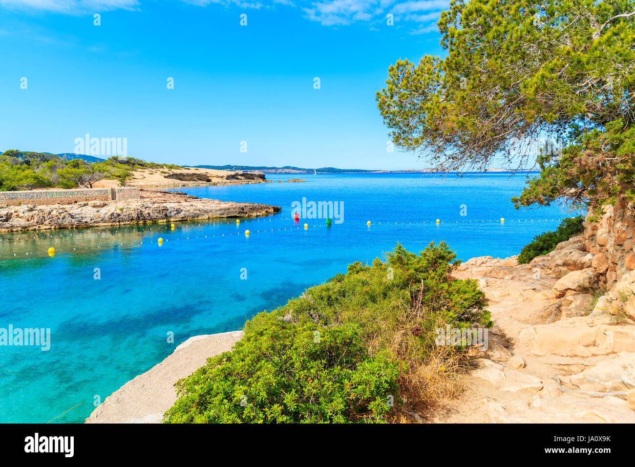 View of coastal path along beautiful Cala Gracio bay at early morning, Ibiza island, Spain Stock Photo