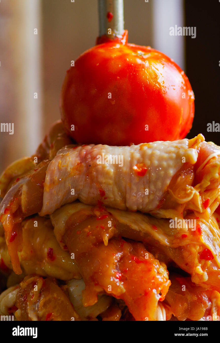 Close up of a delicious slabs of skewered fast food shawarma chicken and lamb meat turn side by side on a spit Stock Photo