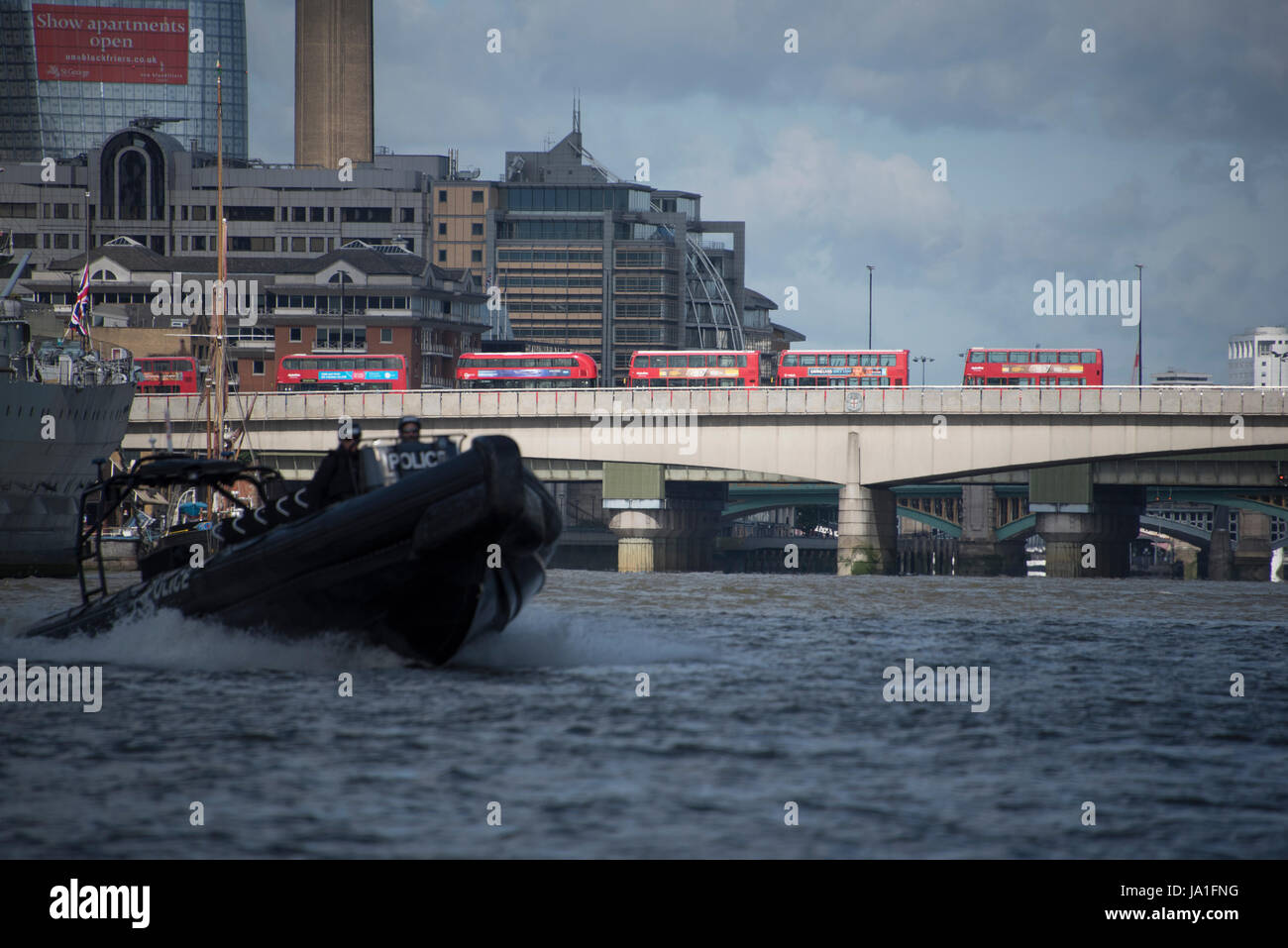 Aftermath of London Bridge and Borough Market terrorist attack, Buses stand idle, Police boat intercepts river traffic, next to HMS Belfast, London, UK. Picture taken from rib in the river between 8 and 9 am, 04th June, 2017. View of London Bridge from Thames river.  Credit: Tony Pincham/Alamy Live News Stock Photo