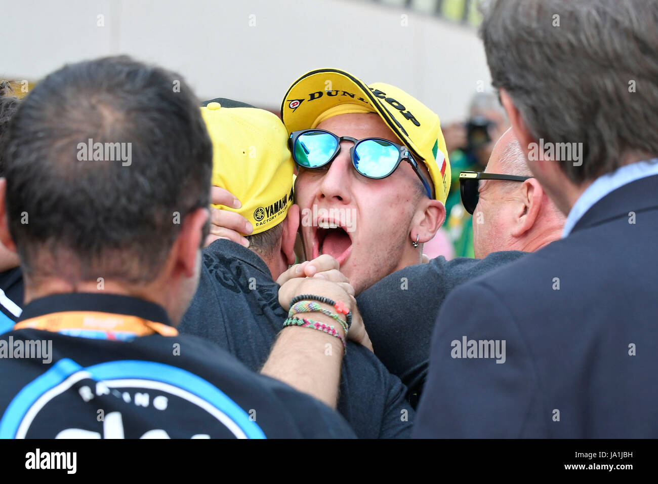 Florence, Italy. 04th June, 2017. SCARPERIA, FLORENCE, ITALY - JUNE 04:, 2017 Andrea Migno of Italy and SKY Racing Team VR46 celebrates his victory under the podium with his Team at the end the race Moto3 during MotoGP Gran Premio d'Italia- at Mugello Circuit. on june 04, 2017 in Scarperia Italy. (Photo by Marco Iorio) Credit: marco iorio/Alamy Live News Stock Photo