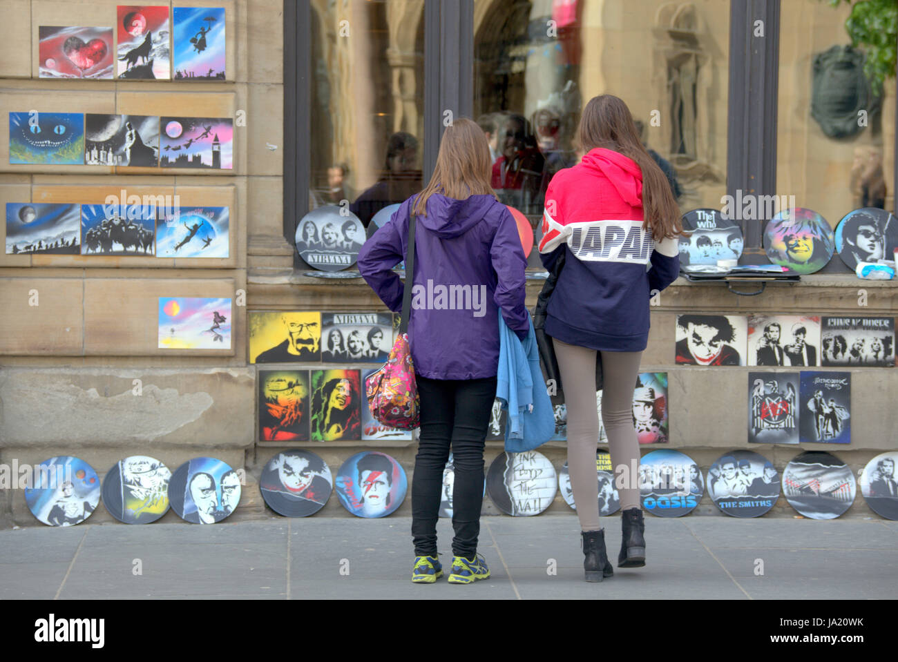 tourists on the streets of Glasgow Scotland buying artworks Stock Photo